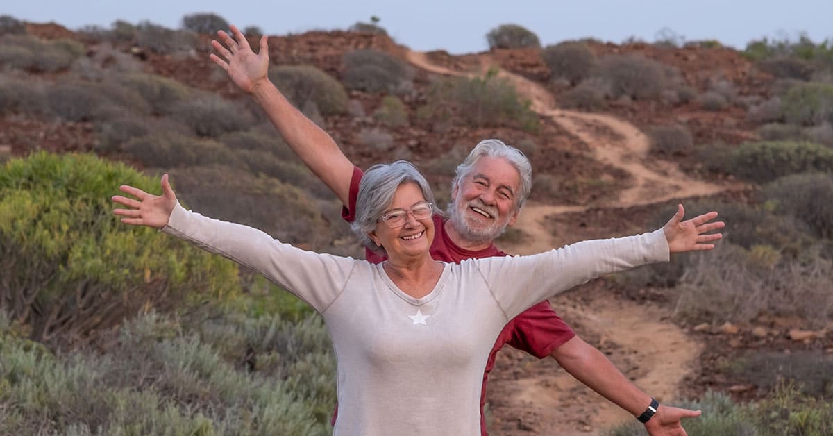 happy seniors in desert landscape